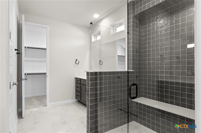 bathroom with a shower with door and vanity