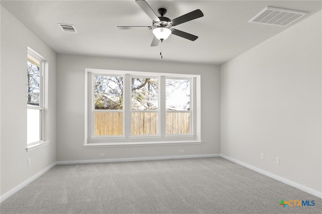 spare room with light carpet and ceiling fan