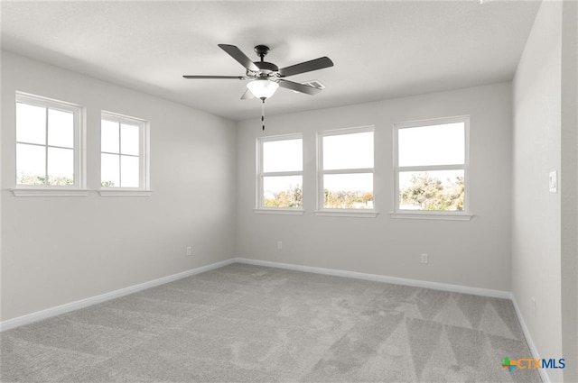 carpeted empty room with plenty of natural light and ceiling fan