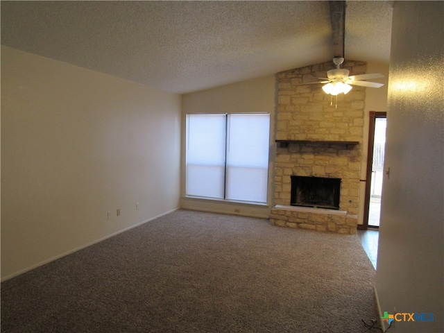 unfurnished living room with a stone fireplace, a textured ceiling, carpet, ceiling fan, and lofted ceiling with beams