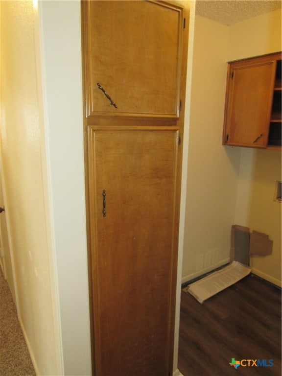 bathroom with hardwood / wood-style floors and a textured ceiling