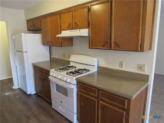 kitchen featuring dark hardwood / wood-style floors and white appliances