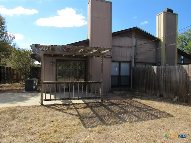 back of house featuring cooling unit and a patio