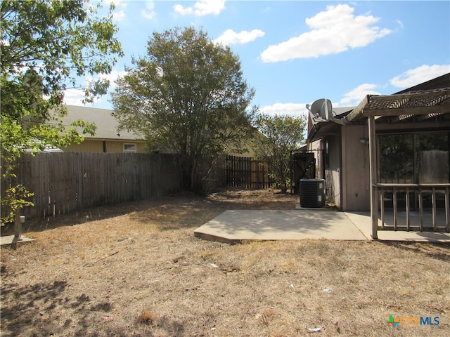 view of yard featuring cooling unit and a patio