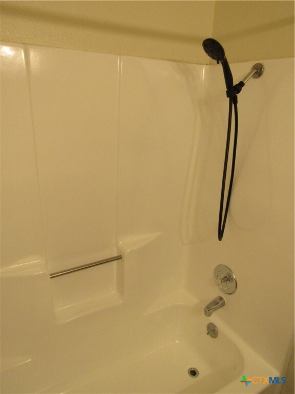 room details featuring shower / bathtub combination