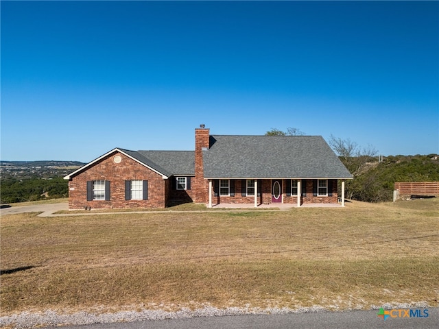 ranch-style home with a porch and a front lawn