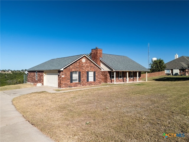 view of front of property with a front yard and a garage