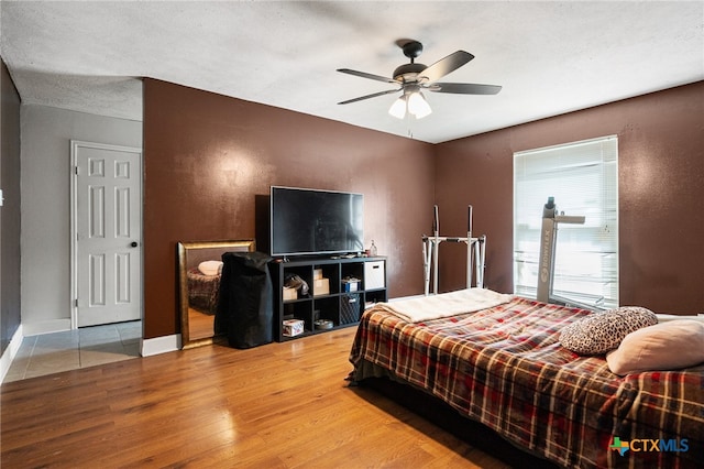 bedroom with ceiling fan and wood-type flooring