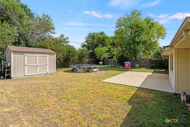 view of yard featuring a storage unit and a patio area