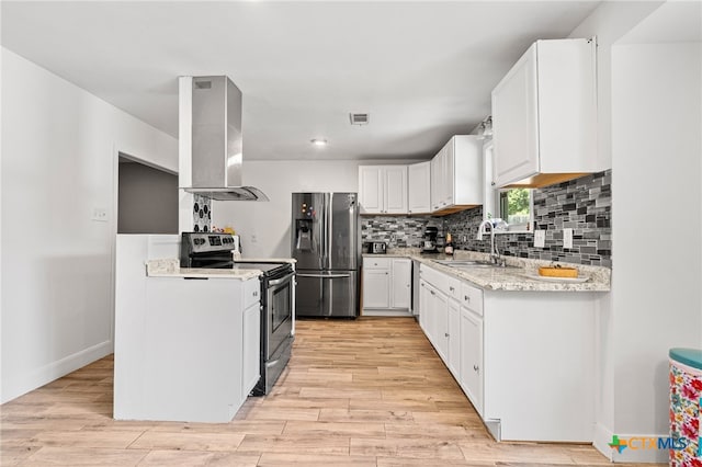 kitchen featuring wall chimney exhaust hood, light hardwood / wood-style flooring, sink, white cabinetry, and appliances with stainless steel finishes