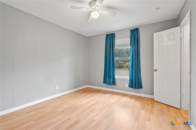 empty room with light hardwood / wood-style floors and ceiling fan