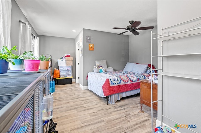 bedroom with ceiling fan and light hardwood / wood-style floors