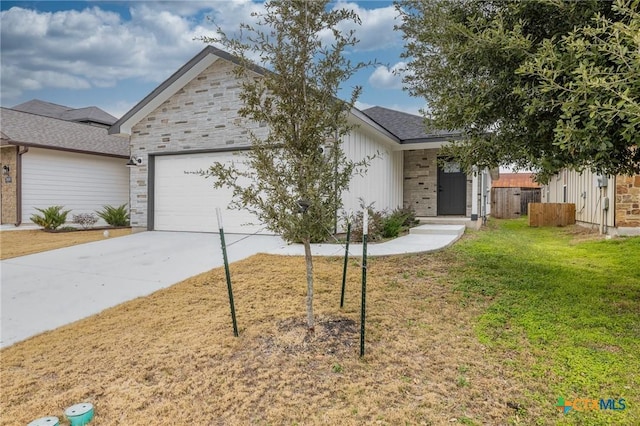 ranch-style house featuring a garage and a front lawn