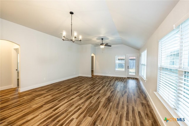 unfurnished living room featuring dark hardwood / wood-style flooring, ceiling fan with notable chandelier, and vaulted ceiling