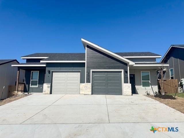 view of front of house with a garage and concrete driveway