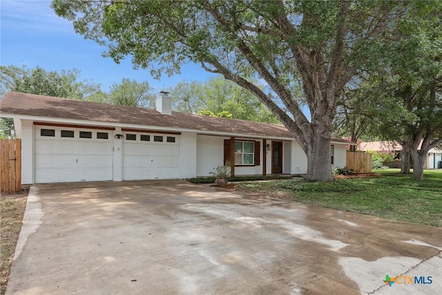 1334 Carnation Ln, New Braunfels, TX 78130 - single story home featuring a garage, concrete driveway, a chimney, and brick siding