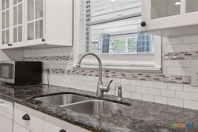 1334 Carnation Ln, New Braunfels, TX 78130 - kitchen featuring stainless steel microwave, white cabinets, white dishwasher, and tasteful backsplash