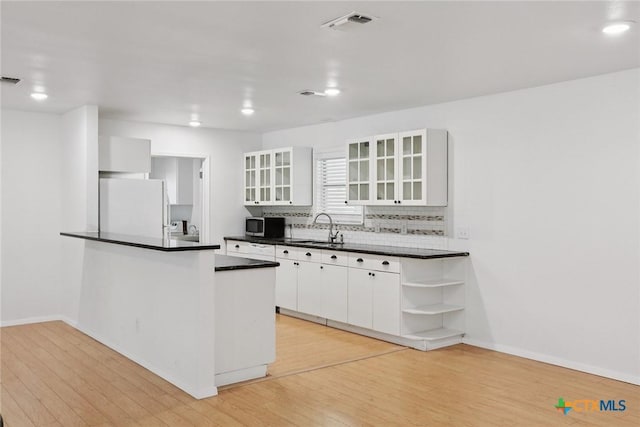 1334 Carnation Ln, New Braunfels, TX 78130 - kitchen featuring refrigerator, stainless steel microwave, dark countertops, white cabinetry, and recessed lighting