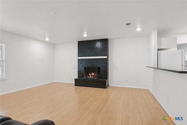 1334 Carnation Ln, New Braunfels, TX 78130 - unfurnished living room featuring wood finished floors, a fireplace, and recessed lighting