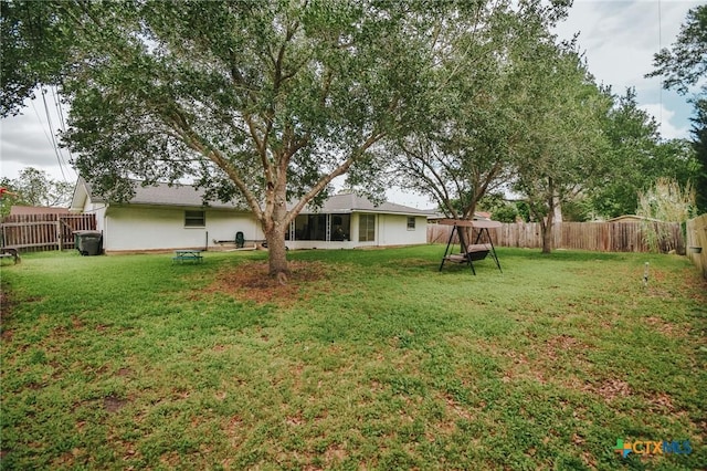 2303 Terrace Ave, Victoria, TX 77901 - view of yard featuring a fenced backyard and a sunroom