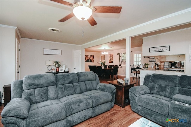 2303 Terrace Ave, Victoria, TX 77901 - living room featuring ceiling fan, light wood-type flooring, visible vents, and ornamental molding