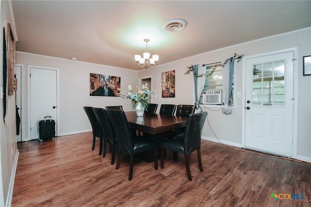 2303 Terrace Ave, Victoria, TX 77901 - dining space with wood finished floors, crown molding, visible vents, baseboards, and a chandelier