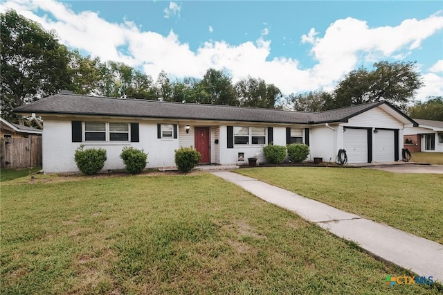 2303 Terrace Ave, Victoria, TX 77901 - ranch-style house with a front yard, a garage, driveway, and fence