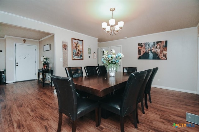 2303 Terrace Ave, Victoria, TX 77901 - dining space with an inviting chandelier, ornamental molding, baseboards, and wood finished floors