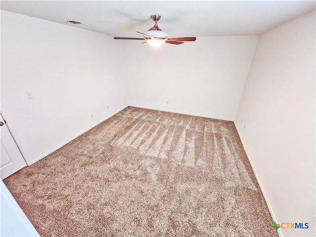 carpeted spare room featuring ceiling fan