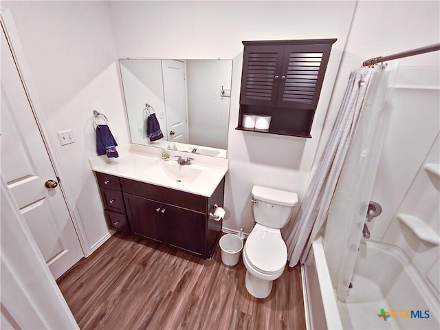 full bathroom featuring toilet, shower / bath combo with shower curtain, vanity, and hardwood / wood-style floors