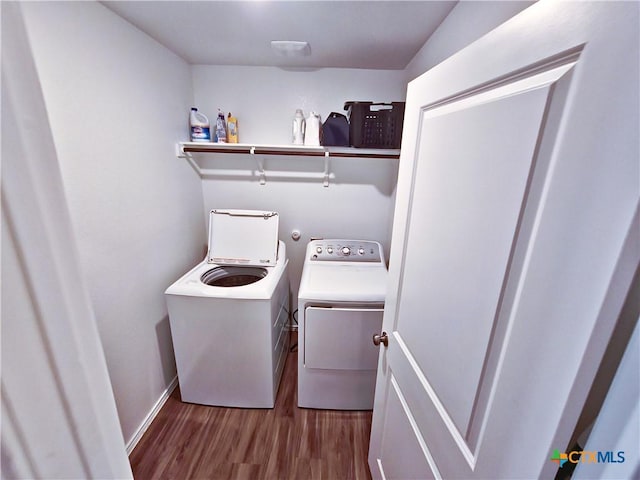 laundry room with washer and dryer and light hardwood / wood-style flooring