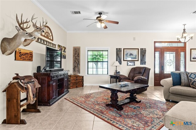 living room featuring ornamental molding, ceiling fan with notable chandelier, and light tile patterned flooring