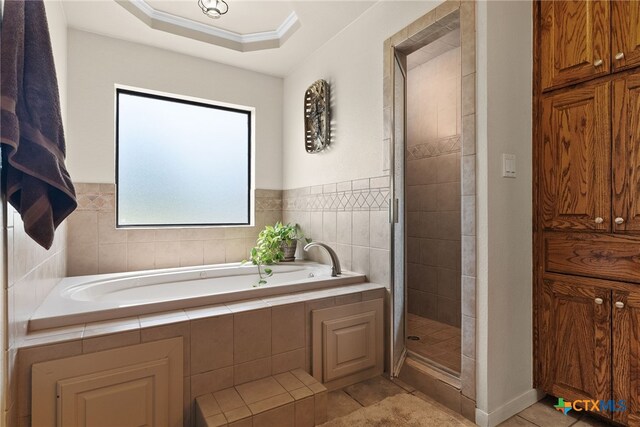 bathroom with independent shower and bath, tile patterned floors, and ornamental molding