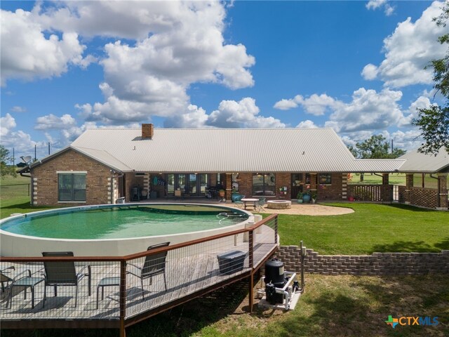 view of pool featuring a lawn and a patio