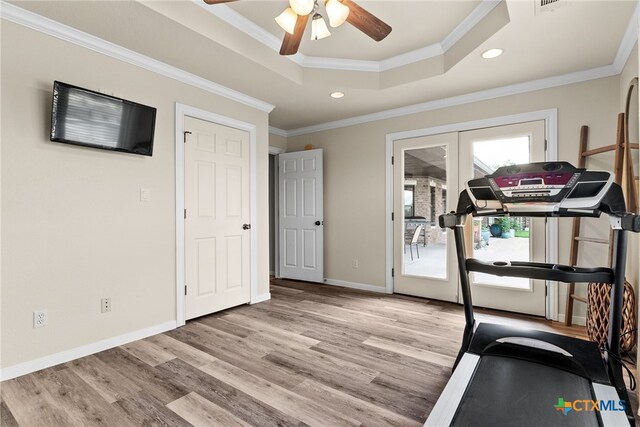 exercise room featuring ornamental molding, french doors, light hardwood / wood-style flooring, and ceiling fan