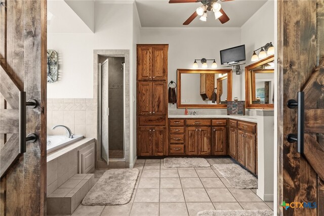 bathroom with ceiling fan, vanity, shower with separate bathtub, crown molding, and tile patterned floors