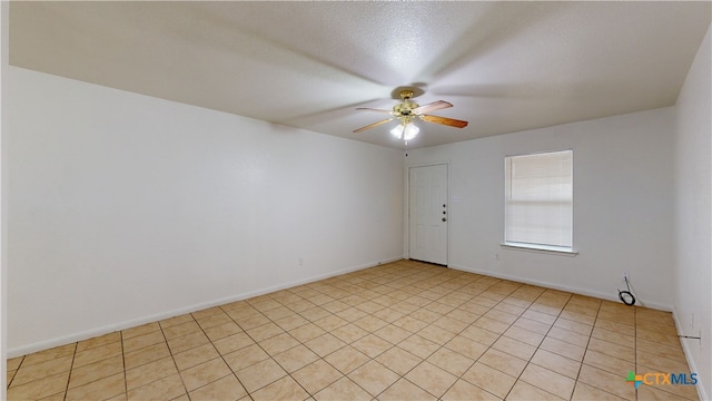 unfurnished room with ceiling fan and baseboards