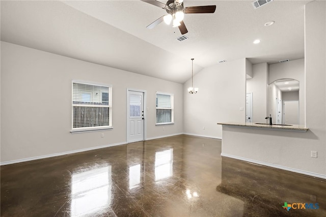 unfurnished living room with lofted ceiling, a healthy amount of sunlight, ceiling fan with notable chandelier, and sink