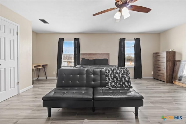 bedroom with multiple windows and ceiling fan