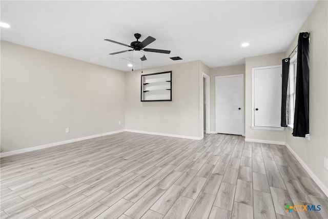 spare room featuring light hardwood / wood-style floors and ceiling fan