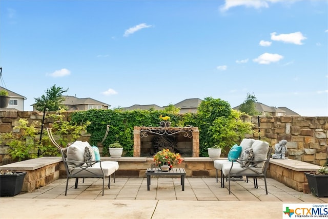 view of patio / terrace with exterior fireplace