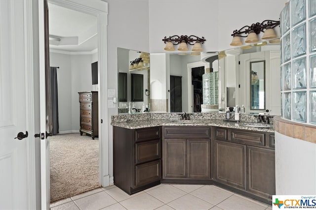 bathroom featuring vanity, tile patterned floors, and a tray ceiling