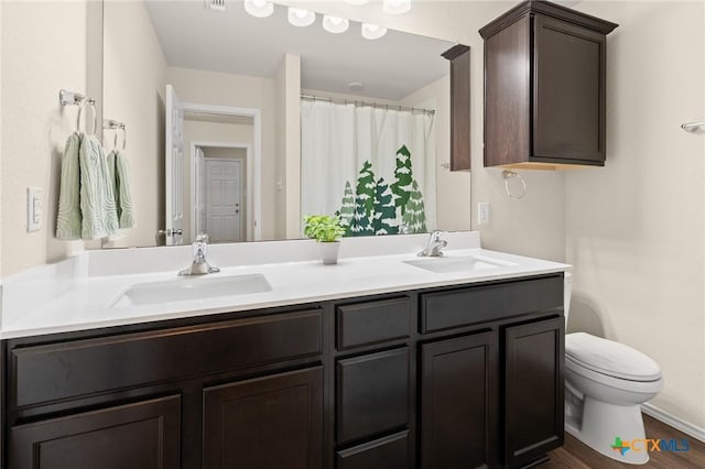 2520 Cortona St, Harker Heights, TX 76548 - bathroom featuring double vanity, wood finished floors, and a shower with shower curtain
