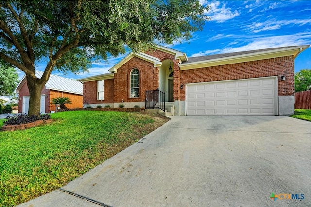 ranch-style house with a garage, a front yard, concrete driveway, and brick siding