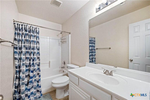 bathroom featuring a textured ceiling, tile patterned flooring, toilet, vanity, and visible vents