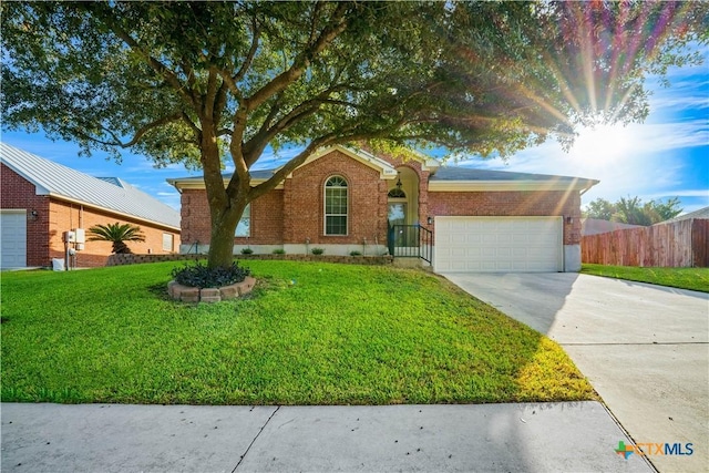 single story home featuring an attached garage, brick siding, fence, driveway, and a front yard