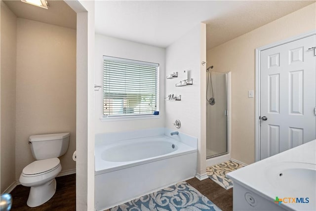 full bath featuring a garden tub, toilet, a shower stall, wood finished floors, and baseboards