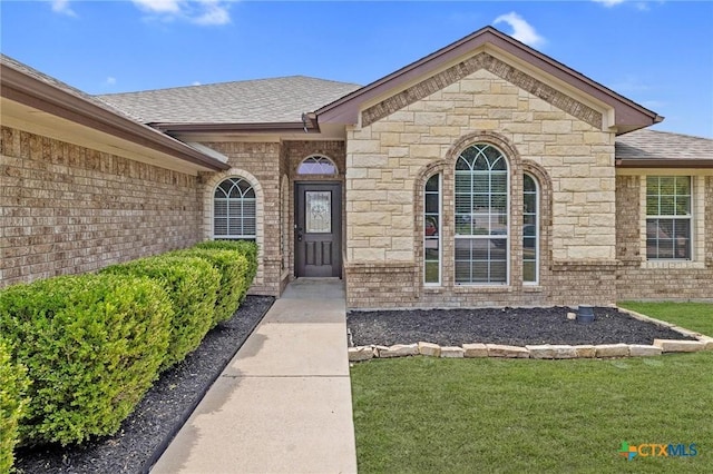 5620 Drystone Ln, Killeen, TX 76542 - entrance to property with roof with shingles, a lawn, and brick siding