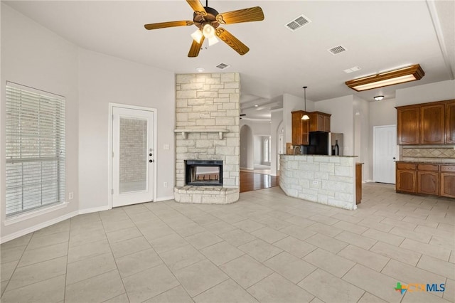 5620 Drystone Ln, Killeen, TX 76542 - unfurnished living room featuring light tile patterned floors, ceiling fan, and a fireplace