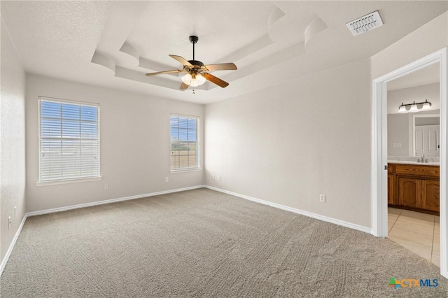 5620 Drystone Ln, Killeen, TX 76542 - spare room featuring light carpet, a raised ceiling, a ceiling fan, a sink, and baseboards